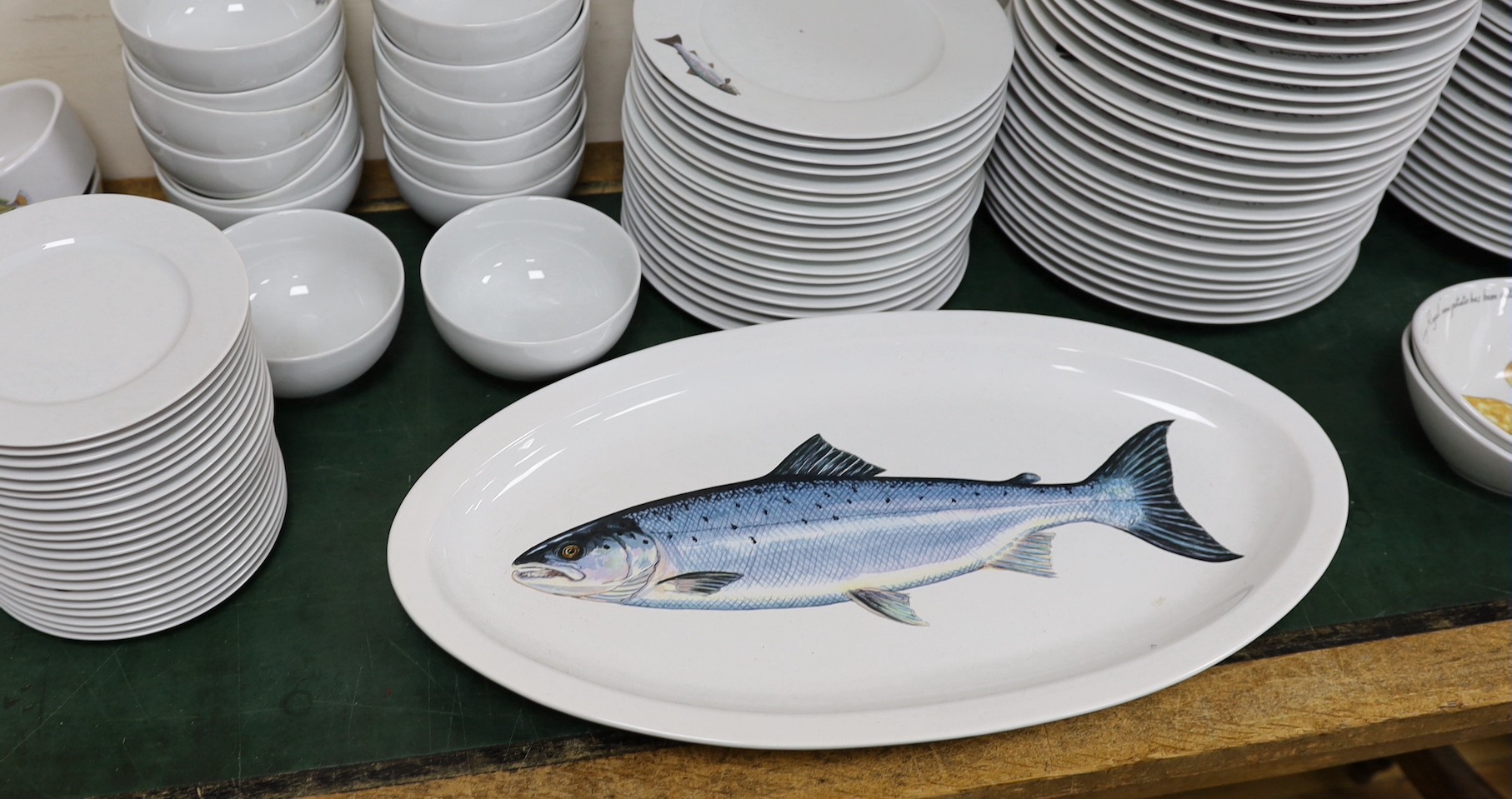 An extensive Richard Bramble for Jersey Pottery dinner service, decorated with fish, cheese etc.